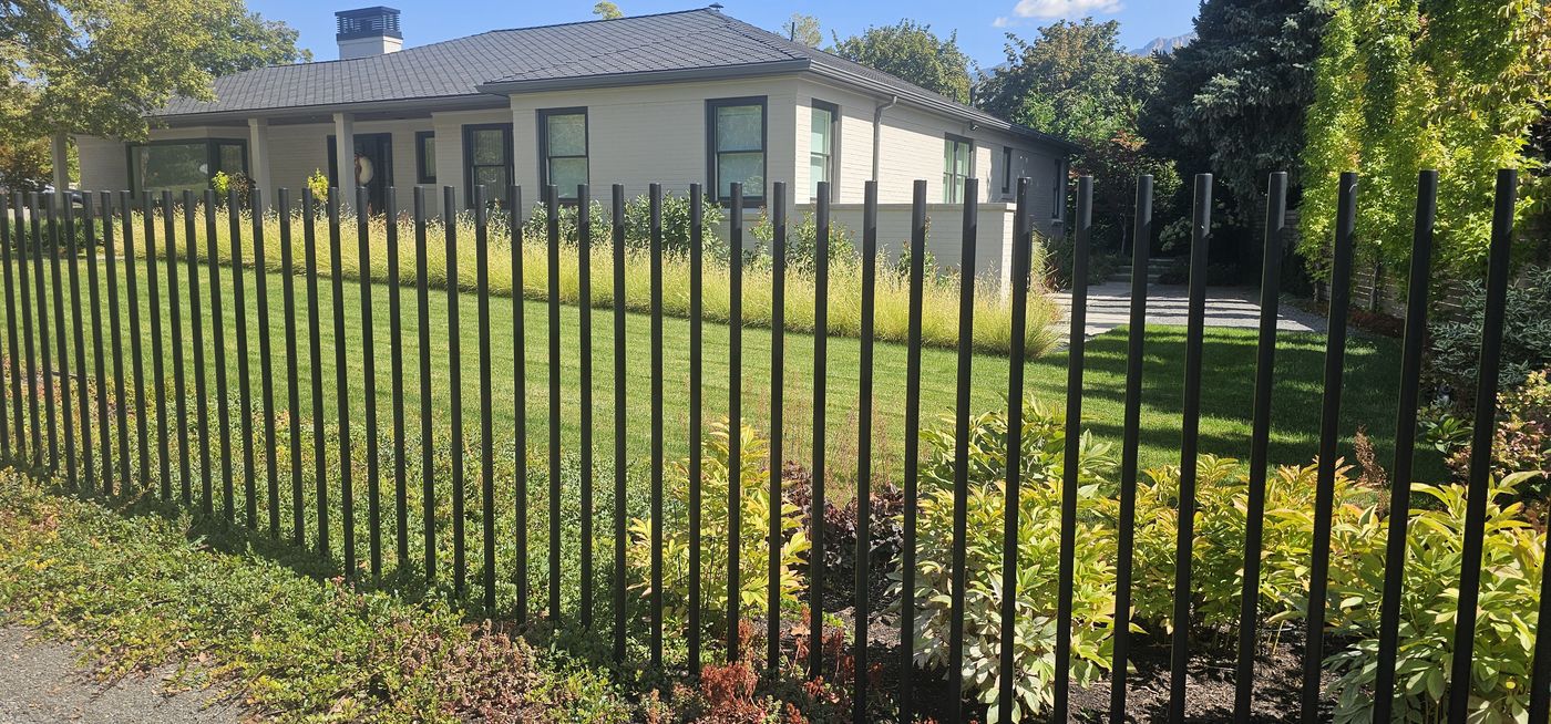Millcreek Residence front lawn behind steel fence