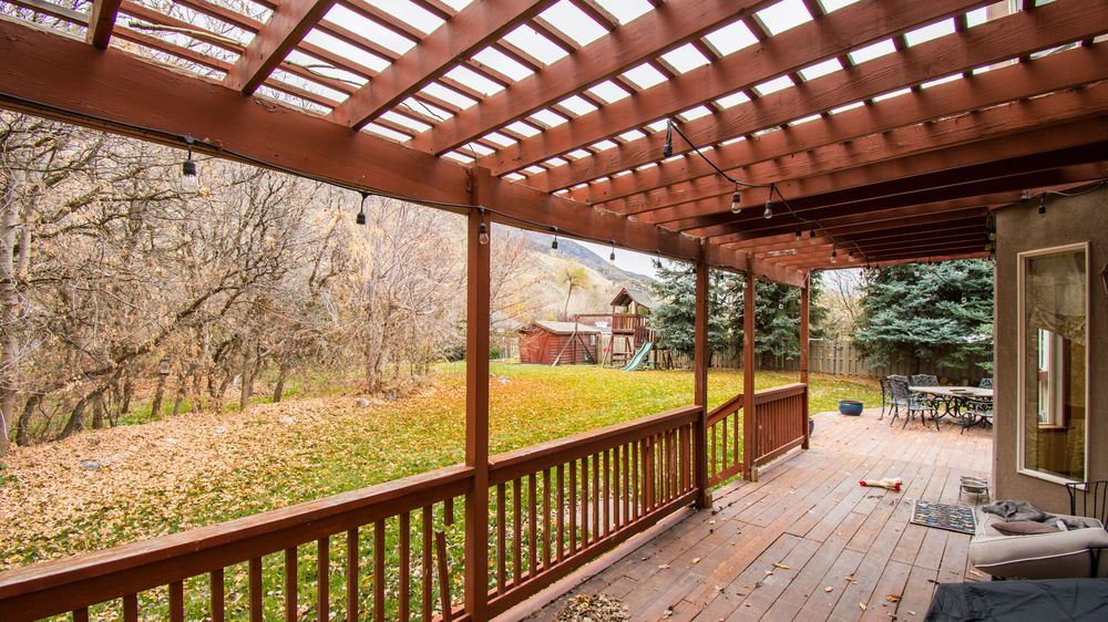 Cedar pergola over a deck looking out to autumn foothills (stock photo)