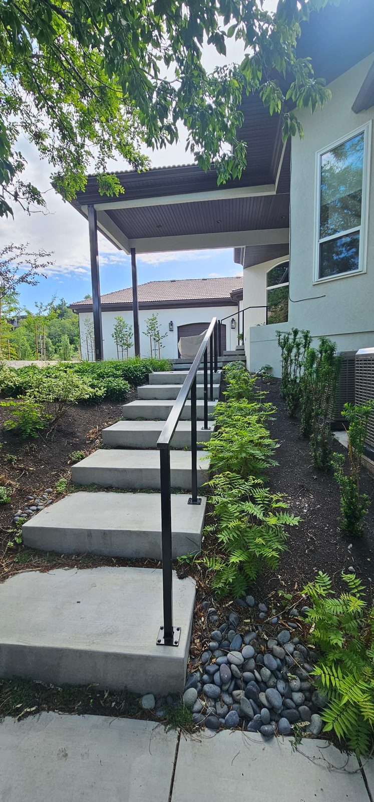 Concrete stairs with steel rail, ferns and river rock, Emigration Canyon